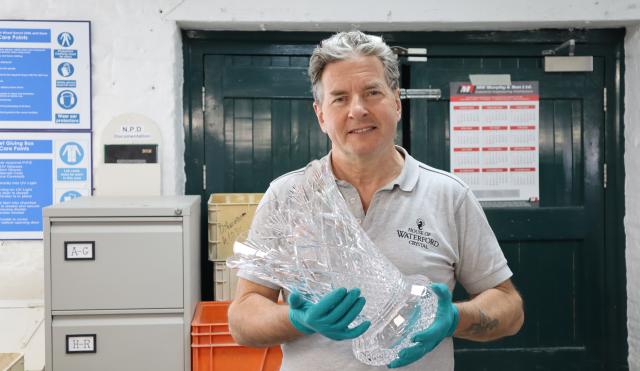 Waterford's Master Sculptor Michael Murphy holding a crystal vase